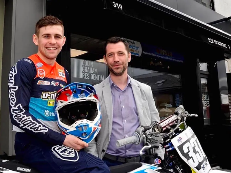 Motocross rider Glenn McCormick with a member of the Colin Graham Residential team outside the Newtownabbey office