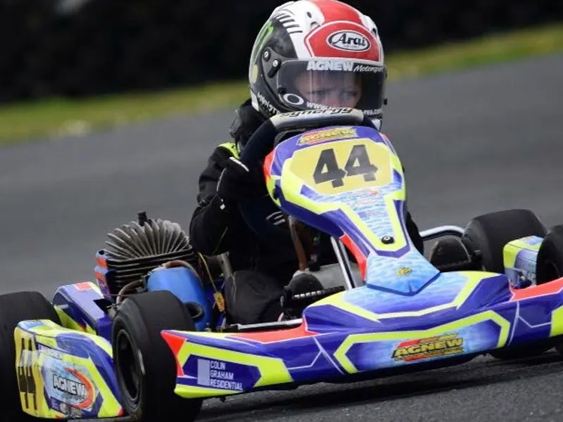 Young kart racer number 44 in an Agnew Motorsport kart carrying the Colin Graham Residential logo